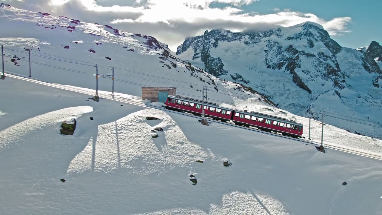 The Gornergrat railway climbing above Zermatt in the snow