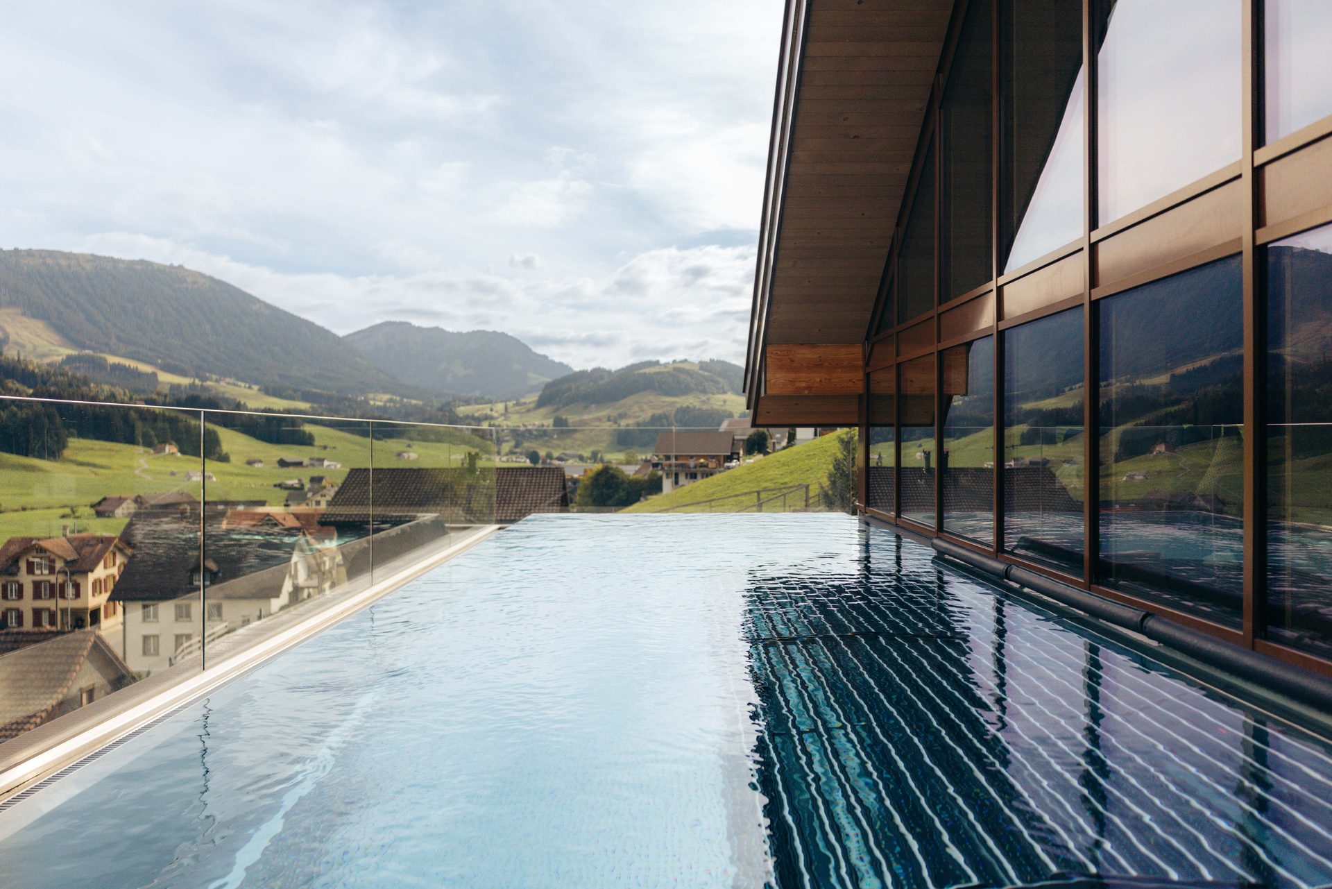 The rooftop pool at Huus Quell, with the hills around Gonten behind
